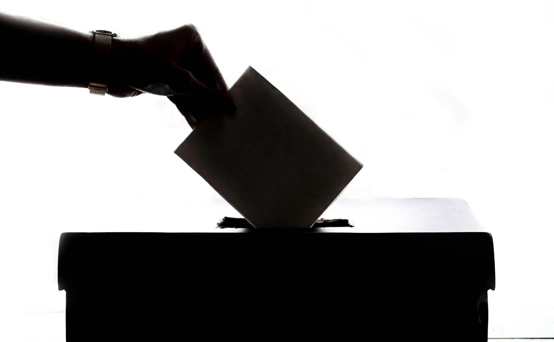https://www.pexels.com/photo/person-dropping-paper-on-box-1550337/